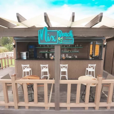 Un bar extérieur au style décontracté et moderne, idéal pour savourer un rafraîchissement en plein air.